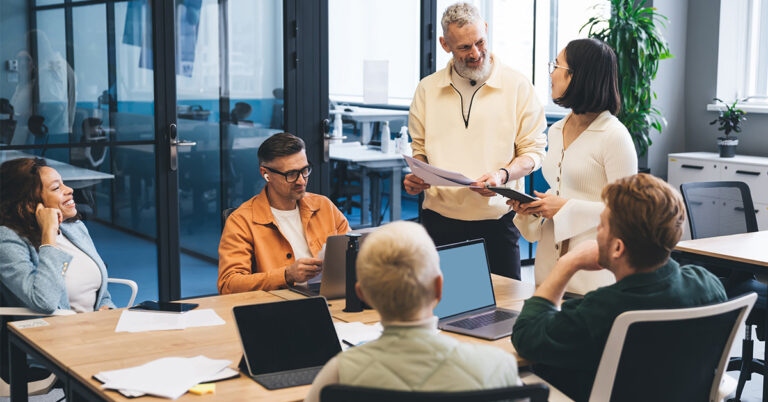 multiethnic colleagues having conversation in office