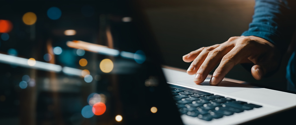 a person typing in a laptop